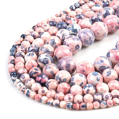 String of pink and purple marbled beads on a white background