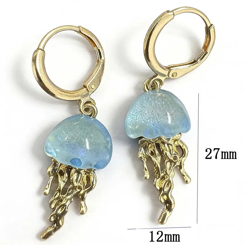 Jellyfish-shaped earrings with gold and blue details on a white background