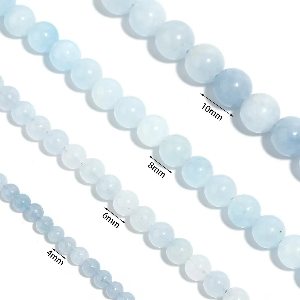 Close-up of light blue beads with size measurements on a white background