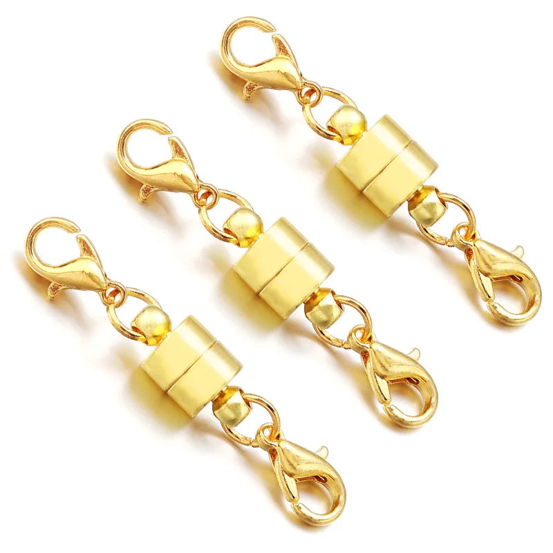 Two gold magnetic clasp connectors on a white background