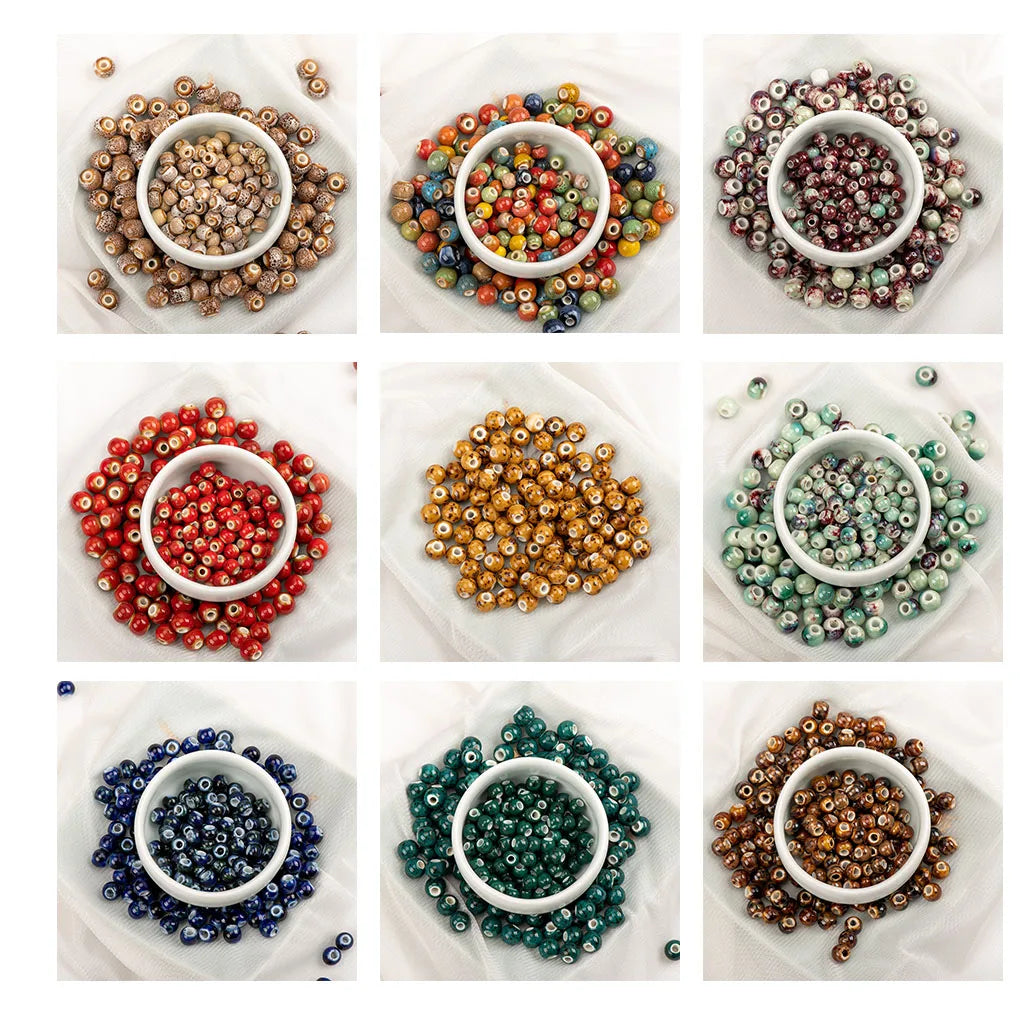 A 3x3 grid showing nine different colors of small round glass beads, each arranged in a small white bowl on a white fabric background.