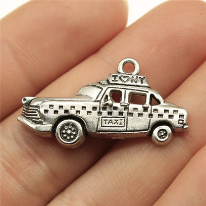Travel charms for jewelry making featuring airplane, passport, suitcase and camera charms.