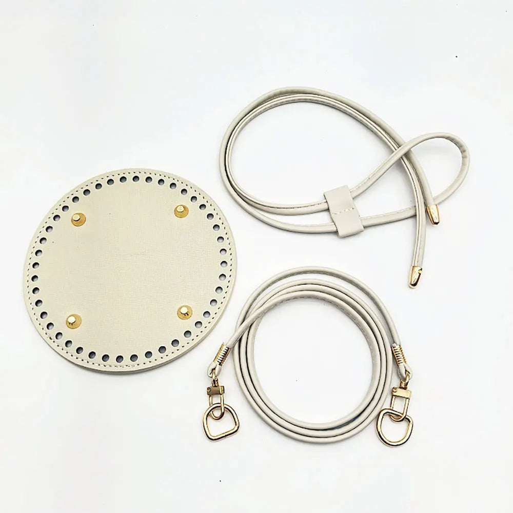 Round beige leather patch with gold studs and two leather straps on a white background