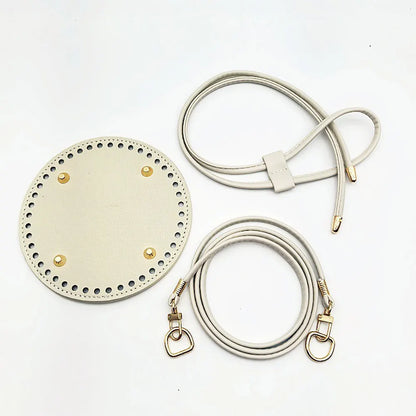 Round beige leather patch with gold studs and two leather straps on a white background