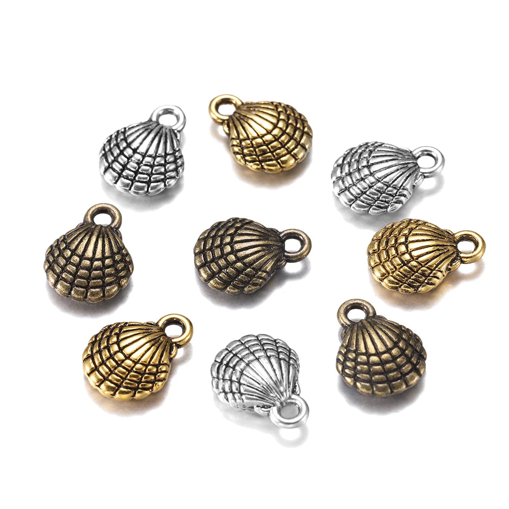 Nine small shell-shaped jewelry charms with loop tops, shown on a plain white background. The charms are finished in two metallic tones: antique gold and antique silver.
