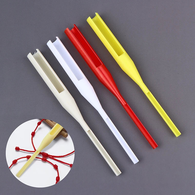 Four plastic fishing line guides in beige, white, red, and yellow, arranged diagonally on a dark gray background, with a circular inset showing one guide attached with red fishing line.