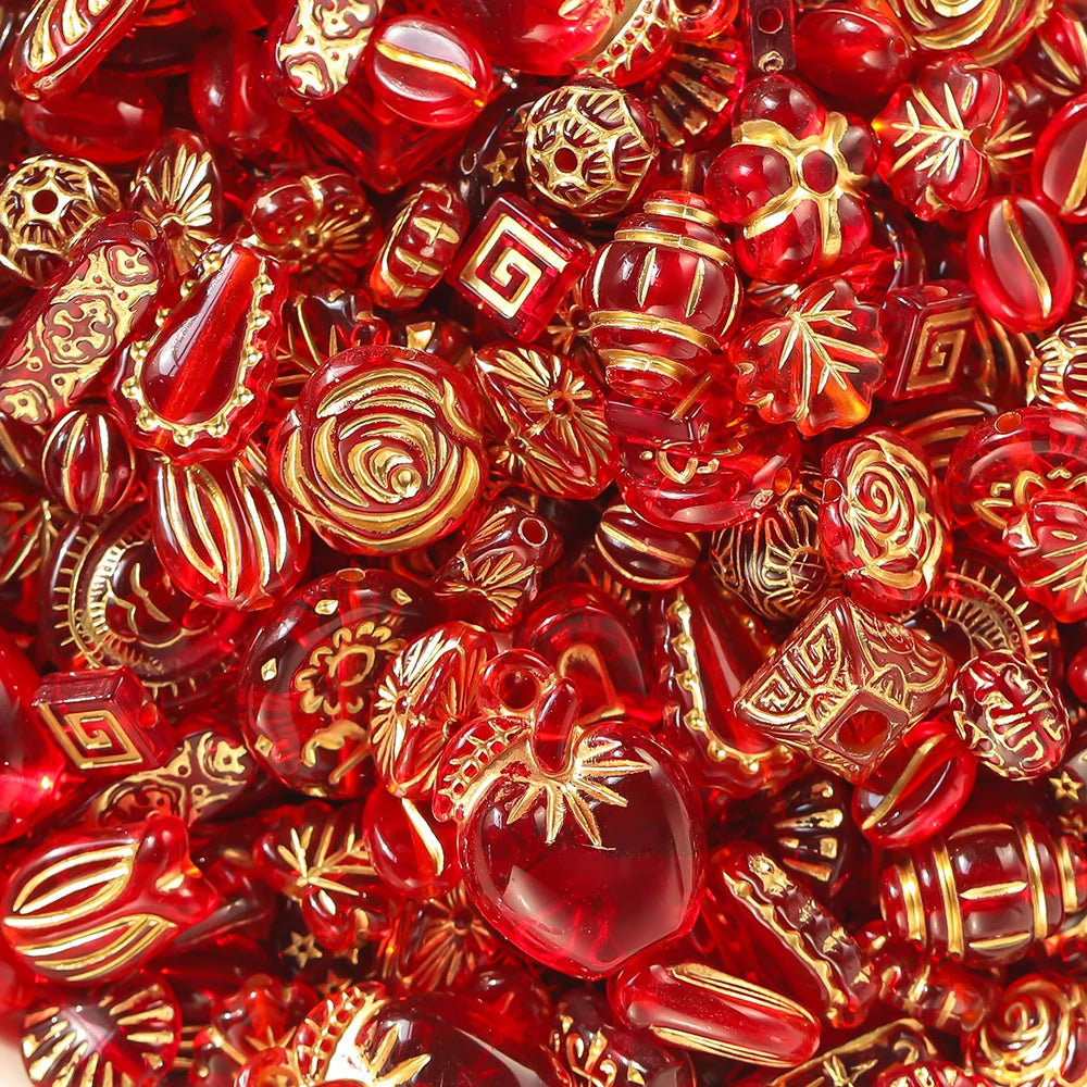 Assorted red and gold beads with decorative patterns