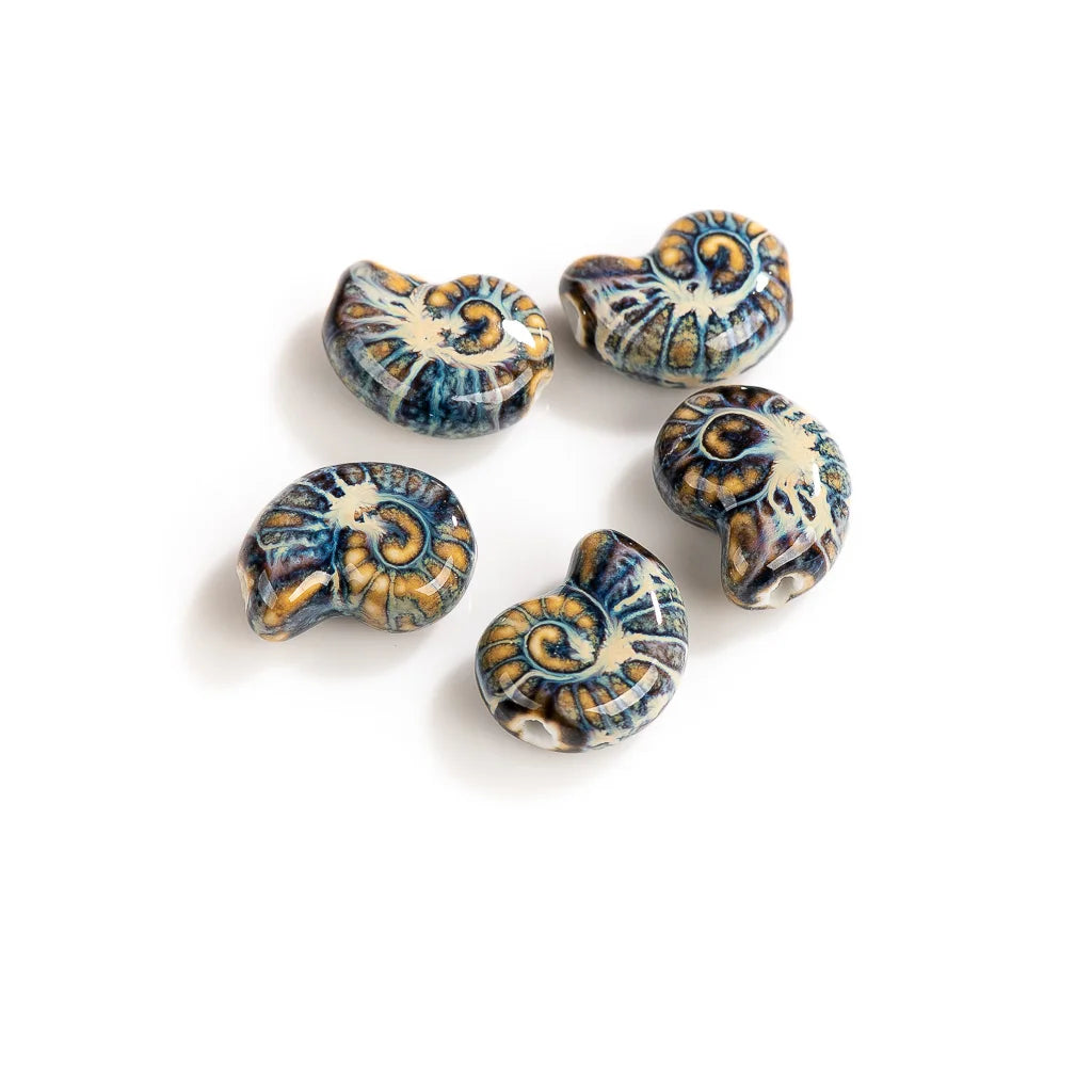 Five ceramic ammolite beads with a detailed shell pattern in blue, gold, and cream, arranged on a plain white background.