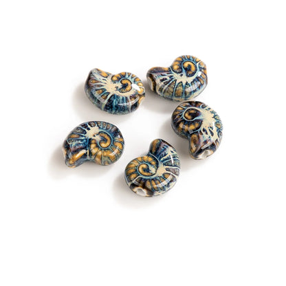 Five ceramic ammolite beads with a detailed shell pattern in blue, gold, and cream, arranged on a plain white background.