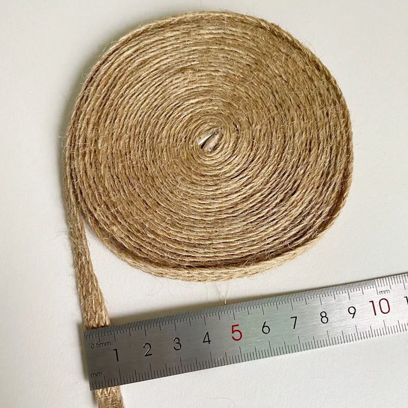 Coiled jute rope with a ruler for scale on a white background