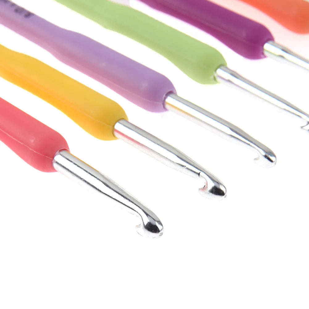Set of colorful crochet hooks on a white background