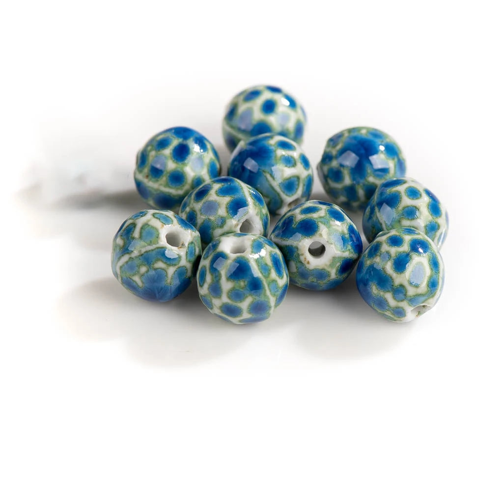 A cluster of round ceramic beads with a blue and white mottled, marbled pattern, shown on a clean white background.