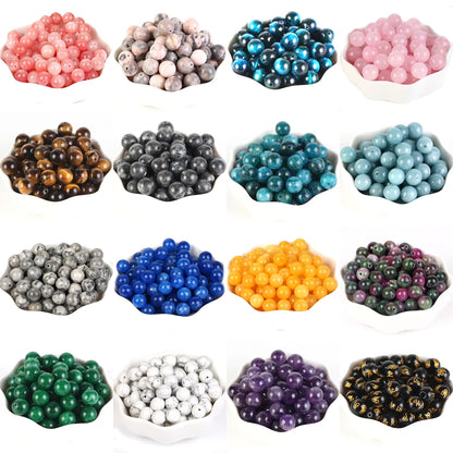 Collection of various colored beads in different containers on a white background