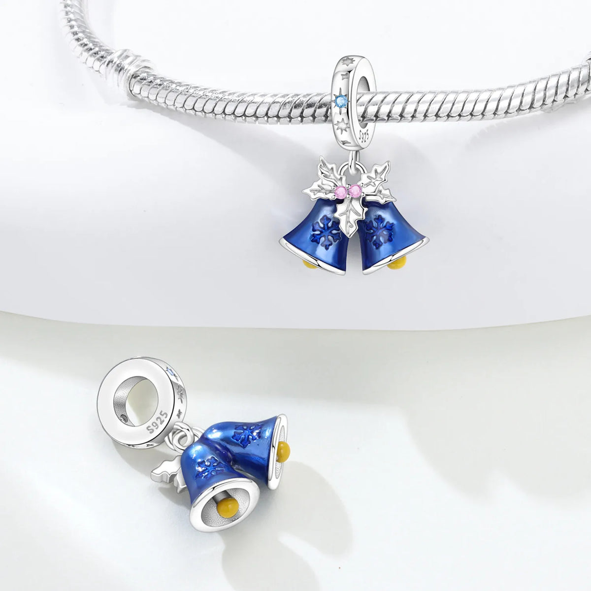 Silver bracelet with blue Christmas bell-shaped charms on a white background