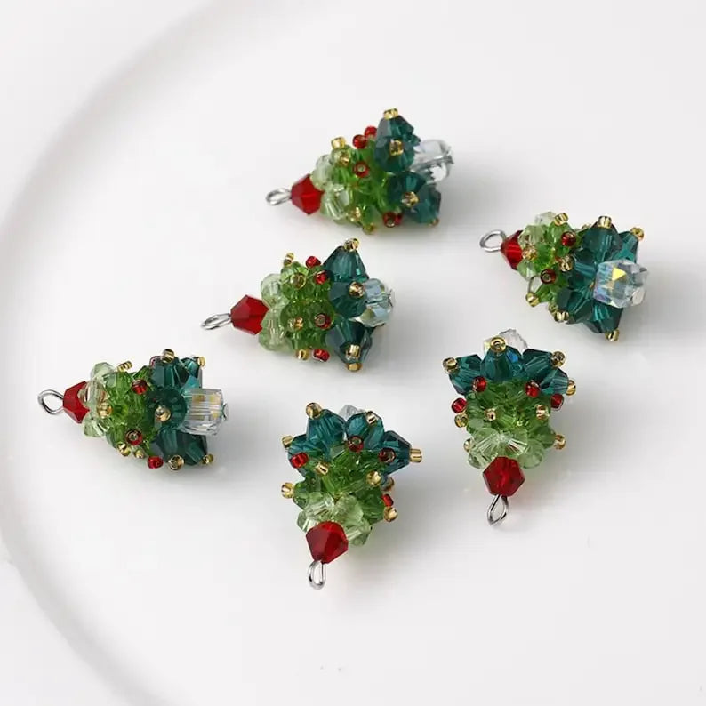 Set of green and red beaded Christmas tree pendants on a white background