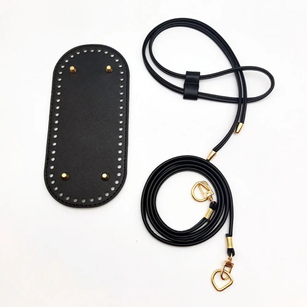 Black purse strap with gold hardware on a white background