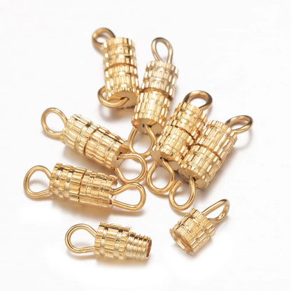 Gold jewelry clasp connectors on a white background