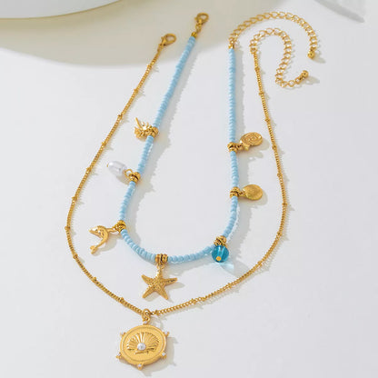 Two necklaces with blue beads and gold accents on a white background