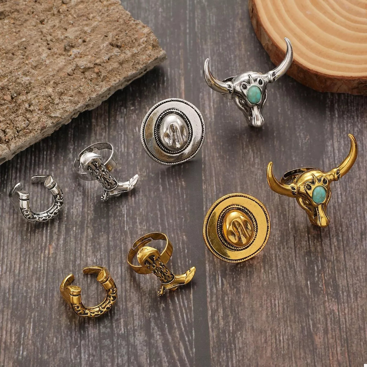 Collection of decorative western charms or rings with cowboy designs on a wooden surface